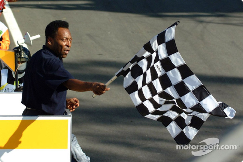 Pelé giving the checkered flag