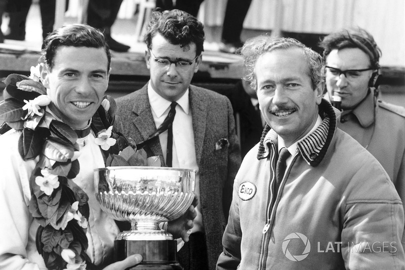 Race winner Jim Clark, Lotus, receives the winners trophy with team boss, Colin Chapman on the podium