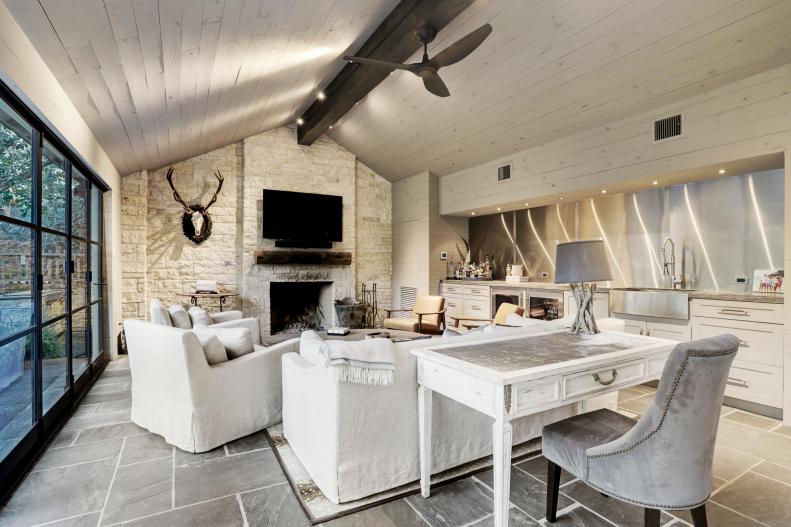 Couches Sit Beneath Arched Ceilings And Mounted TV Above Fireplace
