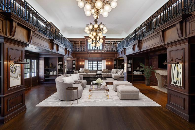 Dark wood-paneled library with golden globe chandeliers.
