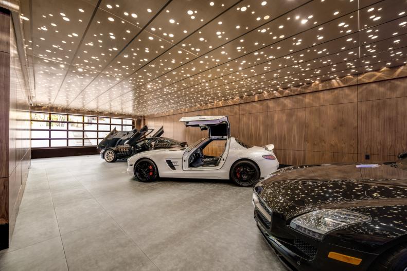 Spacious collector's garage with three custom cars.